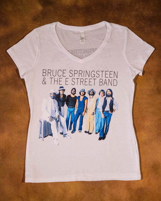White t-shirt with Bruce Springsteen and The E Street Band graphic on a brown background